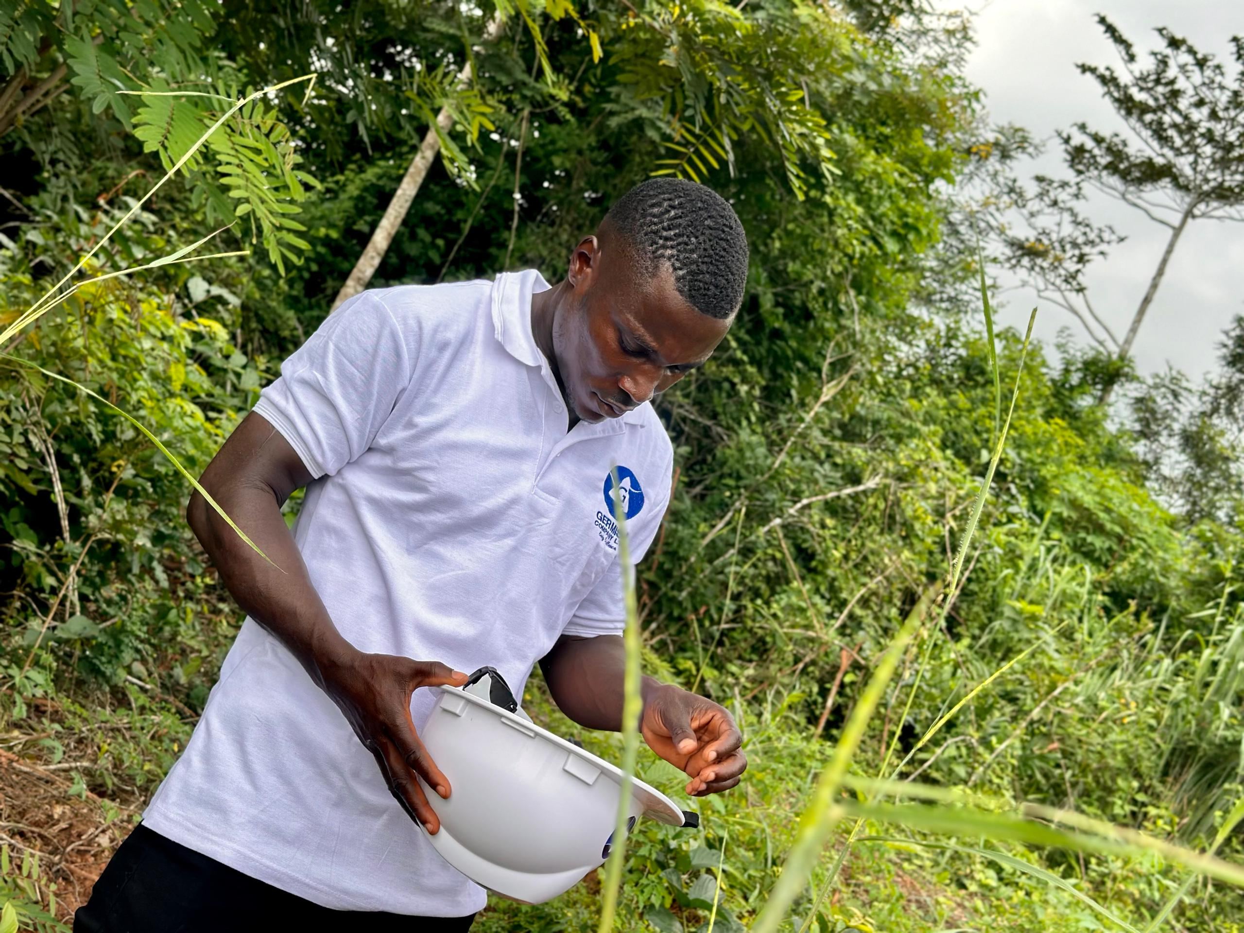 Germisa field officer inspecting crops